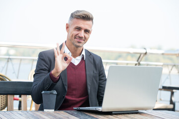 Digital strategy for evolving e-business. Happy businessman show OK ring gesture. E-business