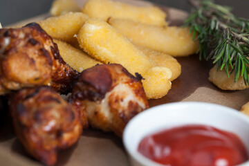 a set of dishes consisting of baked chicken wings , sets in a cafe