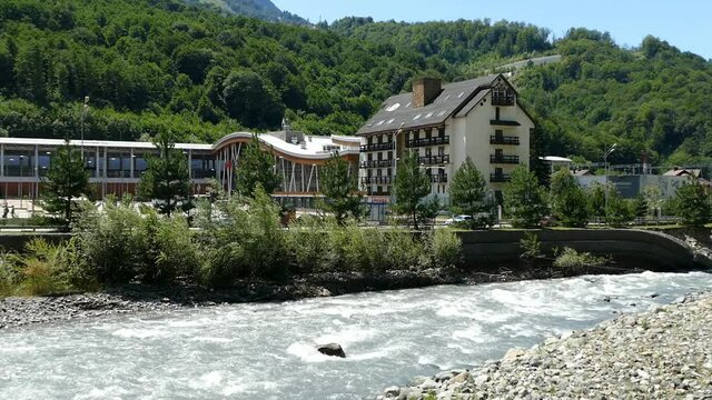 rosa khutor, krasnodar region, russia, 08.08.2021, fast mountain river in the resort rosa khutor 
