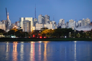 Sao Paulo cityscape viewed from Ibirapuera park lake. Metropolis skyscrapers on background