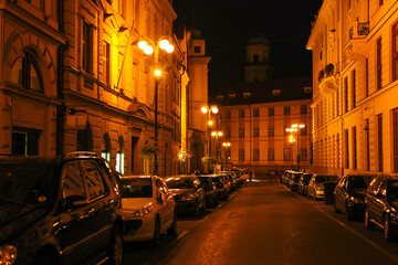 Fototapeta na wymiar Bright lanterns on the streets of the city in the evening. Czech.