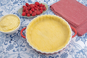 cuisiner une délicieuse tarte aux framboises entières, ingrédients sur la table 