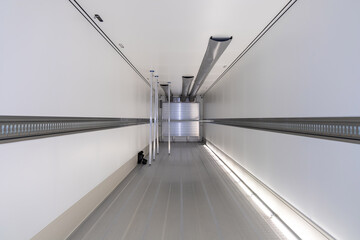 New empty refrigerated semi-trailer inside, with cargo area lighting. Inner space of new...