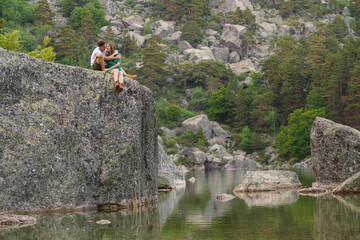 Panoramic view of couple sightseeing in a mountain in the black lagoon in Soria. Horizontal view of wanderlust couple hiking in nature landscape. People and travel destinations in Spain.