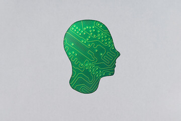 Silhouette of a human cardboard head cutout containing electronic components, revealing circuit...