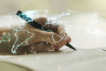 Abstract creative world map and man hand writing in notebook on background, international trading concept. Multiexposure