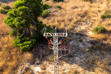 Fototapeta na wymiar electrical tower in the field with high voltage lines.
