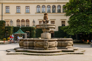 Castolovice, Eastern Bohemia, Czech Republic, 11 September 2021: renaissance castle with tower at sunny day, courtyard with arcades and geometric flower beds, fountain and sgraffito plaster on walls