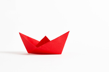 Origami red paper boat on white background