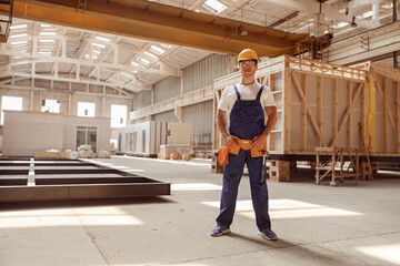 Male worker standing inside building under construction