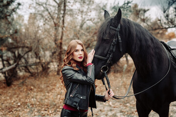 Obraz premium Beautiful young woman posing with a horse outdoors, close up