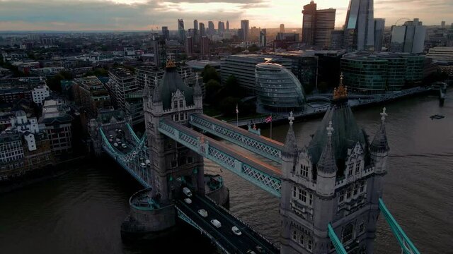 Aerial view to the Beautiful Tower Bridge and skyline of London, UK, just before sunset. Traffic going across the bridge.