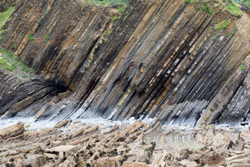 View of the cliff strata above the Sakoneta beach, part of the flysch of the Basque Coast Geopark. Taken in Euskadi in July 2021