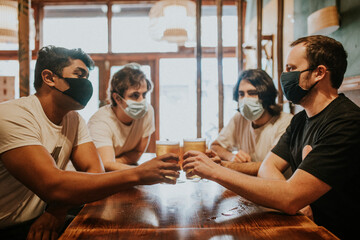 Friends having beers, mask in the new normal HD image