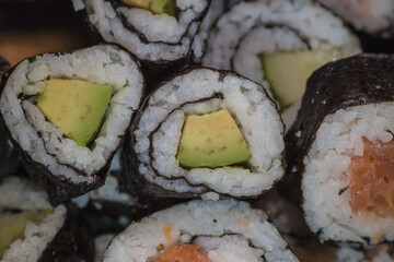 sushi rolls with rice cucumber salmon layered