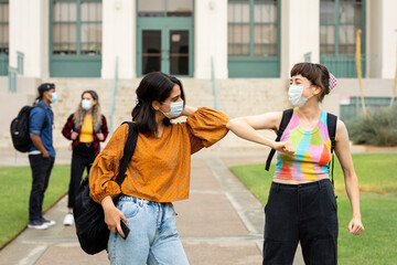 Obraz premium Elbow bump greeting at school in the new normal