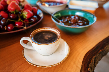 Espresso coffee cup with various desserts and fruits