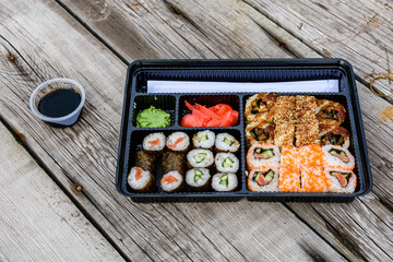 Set of the different sushi on wooden table