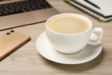 Coffee Break at workplace. Cup of hot drink on wooden table