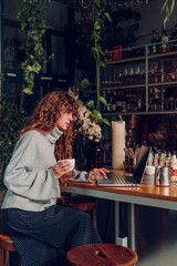 Business woman with curly hair working at the remote office