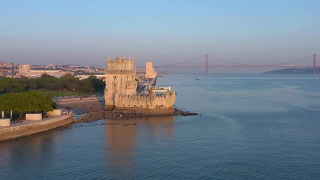 Lisbon, Portugal, aerial view of Belem Tower, Torre de Belem. By the Tagus river at sunset, Bridge 25 Abril