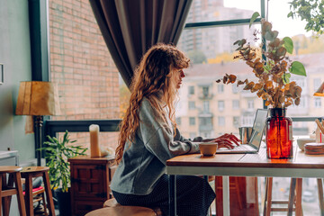 Business woman with curly hair working at the remote office