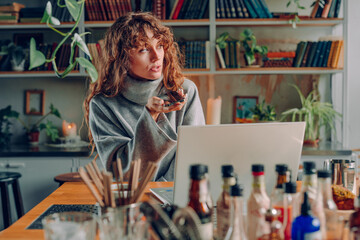 Smiling young woman freelancer working at the vintage cafe using smartphone