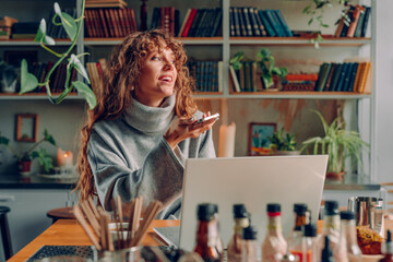 Smiling young woman freelancer working at the vintage cafe using smartphone