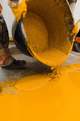 epoxy flooring applicator performs painting works with polyurethane epoxy mortar