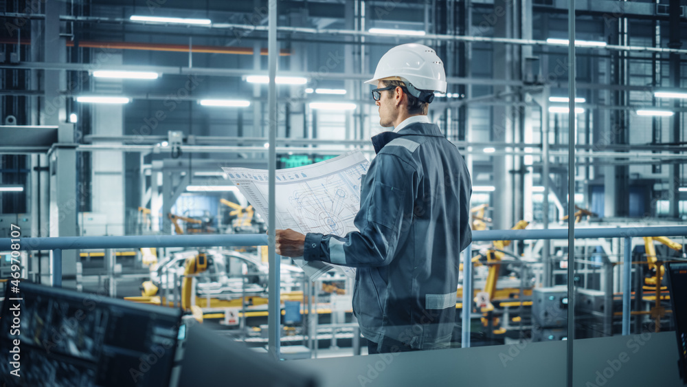 Poster Engineer in Uniform and Hard Hat Looking at a Technical Blueprint at Work in an Office at Car Assembly Plant. Industrial Specialist Working on Vehicle Parts in Technological Development Facility.