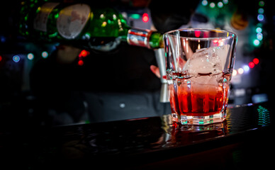 woman hand bartender making negroni cocktail in bar