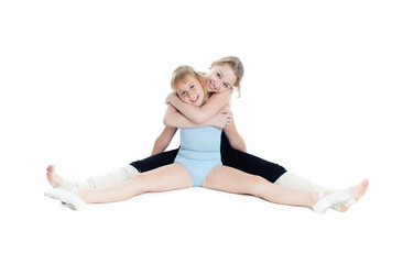 Two sisters gymnasts work together to perform gymnastic exercise. Isolated on white background.
