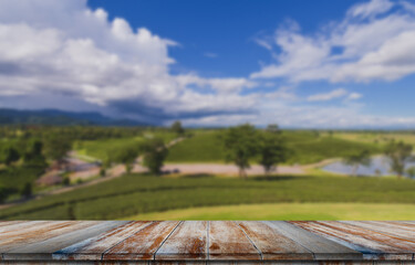 Fototapeta na wymiar Empty wooden floor with blurred tea plantations Can be used for product display editing.