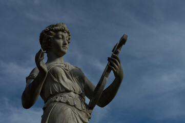 stone statue playing harp