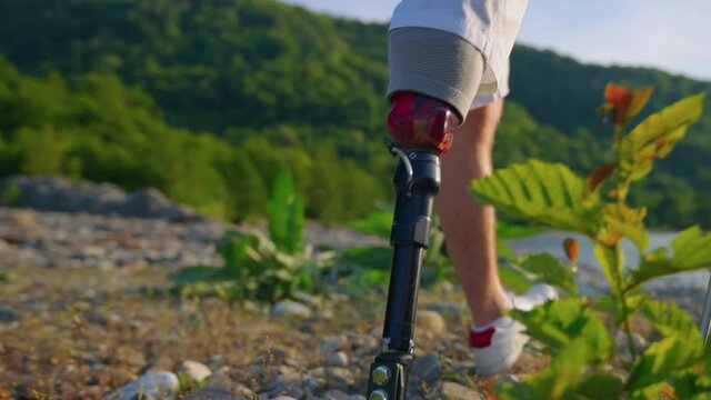 bionic prosthetic leg for sporty man, person is hiking and walking in nature, close up