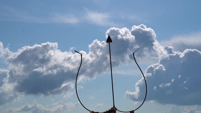 View of the Shiva Trishul in front of the clouds above the mountains at Bijli Mahadev Temple at Kullu in Himachal Pradesh, India. Trident of lord shiva in front of the snow covered mountains.	