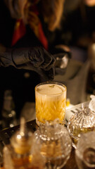 Cropped view of cocktail preparation. The barman is preparing a drink.