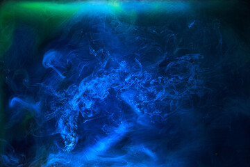 Fototapeta na wymiar Blue smoke on black ink background, colorful fog, abstract swirling ocean sea, acrylic paint pigment underwater