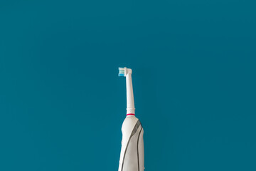 Electric toothbrush. Modern rechargeable sonic or electric toothbrush on isolated background. Concept of professional oral care and healthy teeth