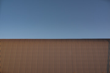 Tinplate and metal architectural wall of the building against the sky