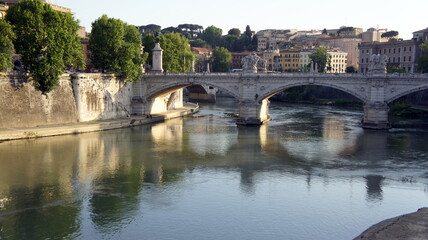Fototapeta na wymiar Rome, Italy, 2011, embankment, bridge over the river, reflection in the water