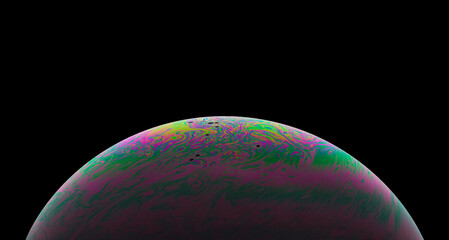 Virtual reality space with abstract multicolor psychedelic planet. Closeup Soap bubble like an alien planet on black background.