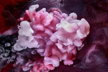 Pink smoke on black ink background, colorful fog, abstract swirling touch ocean sea, acrylic paint pigment underwater