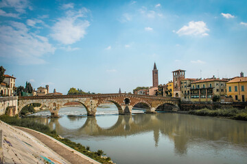Verona, Italy, August 2017, bridge over the river, reflection in the water, embankment of the river