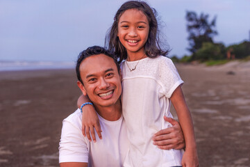 Fototapeta premium holidays, children and family concept -asian outdoor portrait of dad with his teen daughter