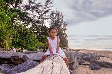 summer, childhood, leisure and people concept- asian cute girl smiling on the beach