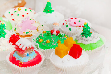 Homemade cakes, cupcakes, muffins decorated in a Christmas style.