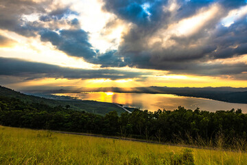 Naklejka na ściany i meble The evening sun shines through the clouds on Lam Ta Khong Reservoir, Nakhon Ratchasima Province, Thailand.