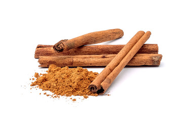 Herb, heap of dried cinnamon bark and powdered cinnamon, isolated on a white background.