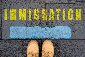 concept message in the road with feet - immigration